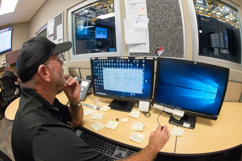 Operator at a multi-monitor workstation