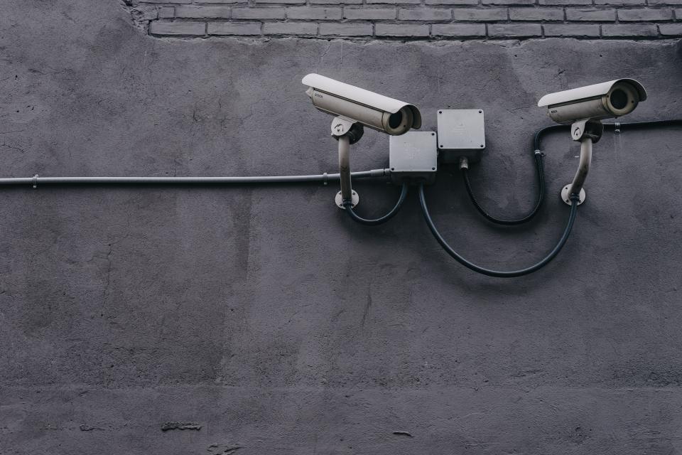 Security camera on a concrete wall